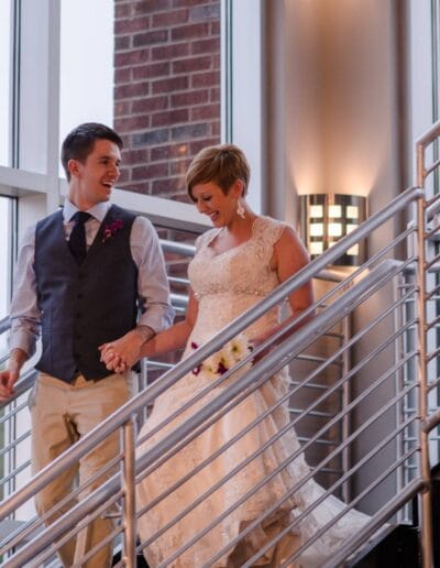 bride and groom entering reception on grand staircase