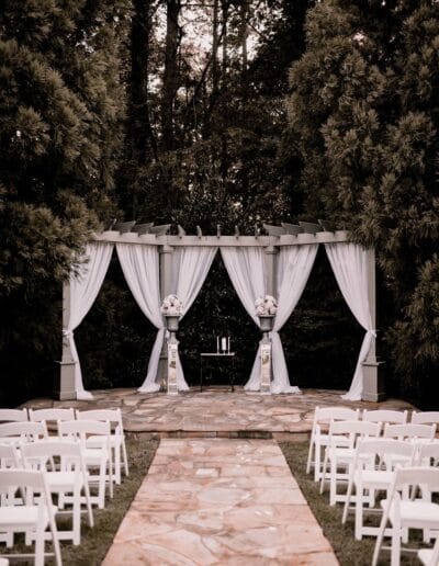 Outdoor wedding ceremony spot with chairs and flowers