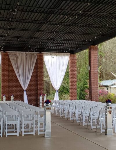 Rows of empty chairs outside on patio with decor