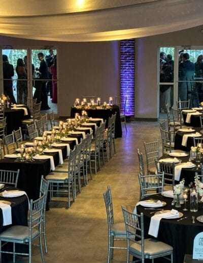 Elegant event setup with tables and decor.